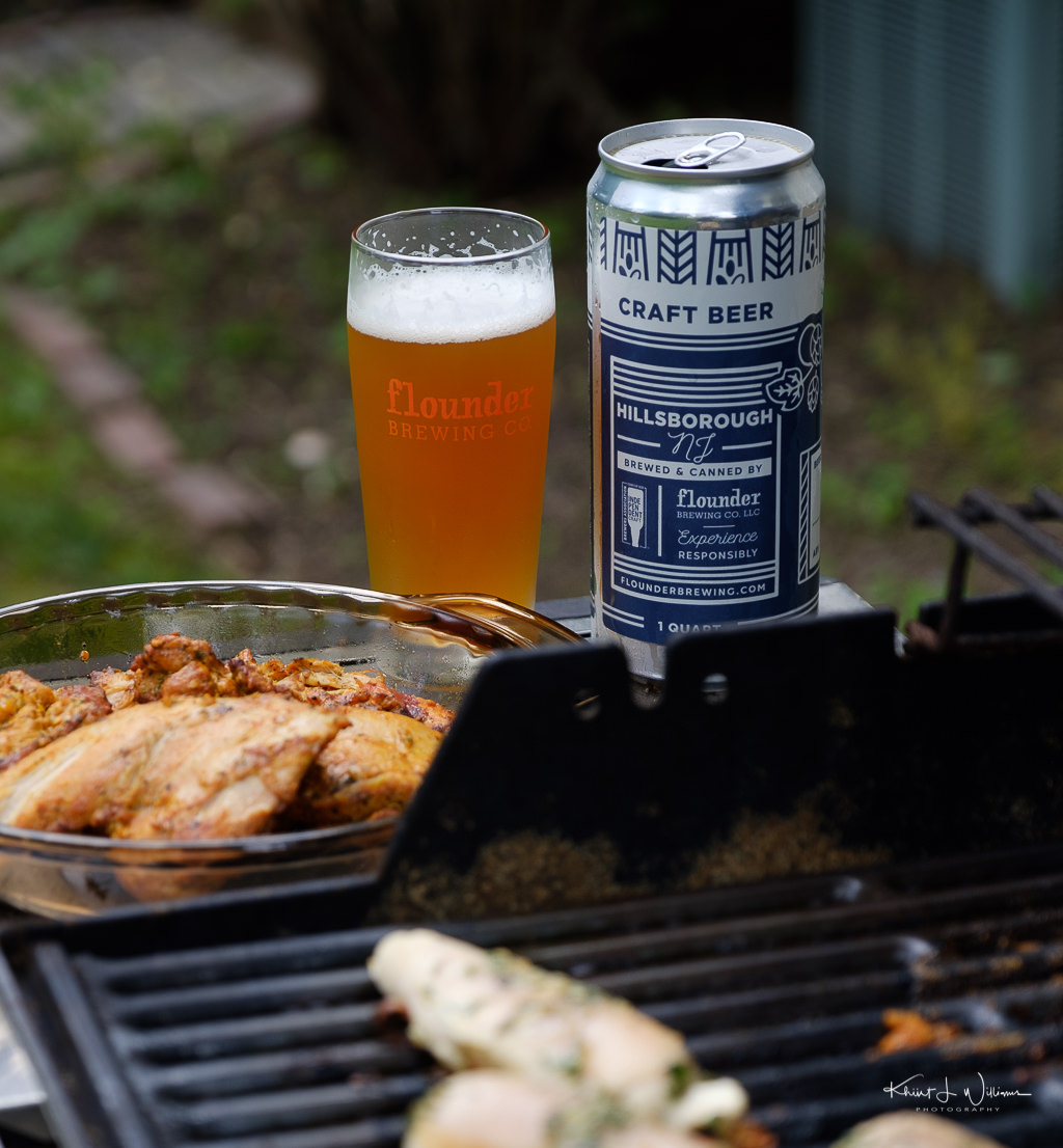 Beer in glass with chicken on grill