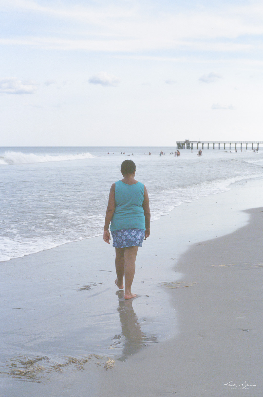 Woman walking on sand at Avalon Beach