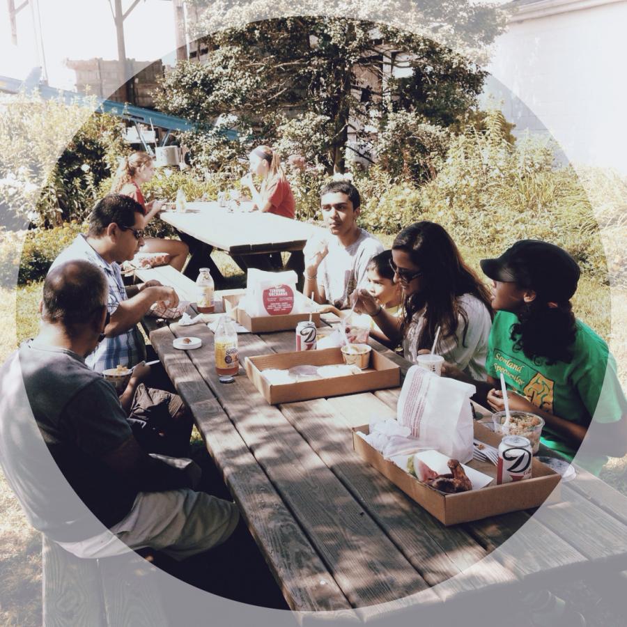 people eating at a picnic table